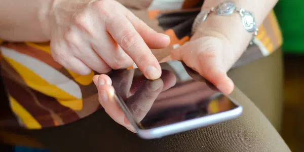 Self-service shown with lady with phone in her hand